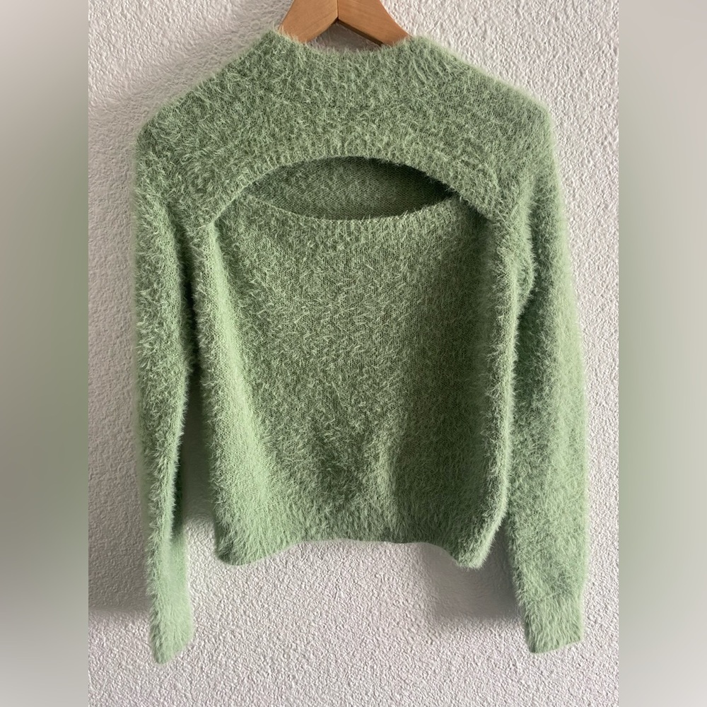 Light green fuzzy sweater. Cut out on the front.